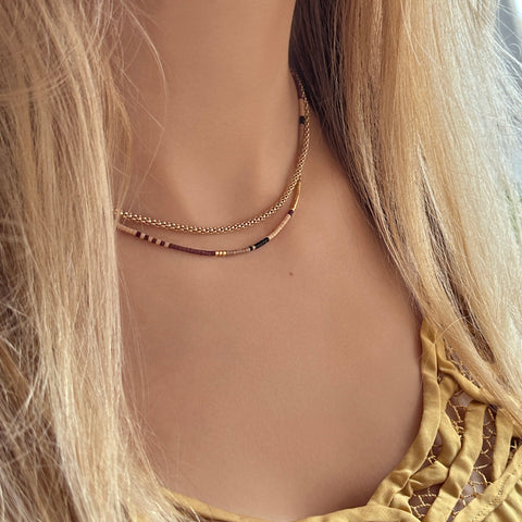 Elegant gold tube necklace by Kurafuchi.
