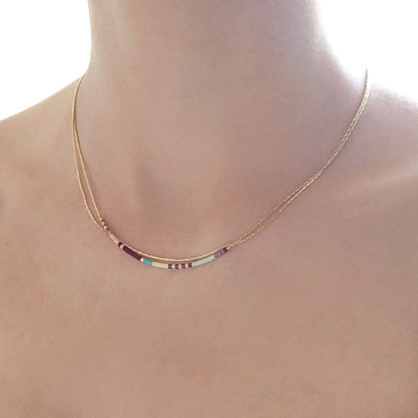 A female model wearing an Elvira minimalist dainty double necklace by Kurafuchi Jewelry.