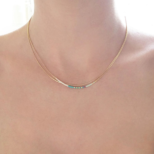 A female model wearing an Elvira minimalist dainty double necklace by Kurafuchi Jewelry.