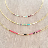 Elvira necklace made of double dainty gold chain decorated with tiny beads in a colorful pattern. Designed by Kurafuchi.