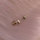 Pretty teardrop-shaped stud earrings with green zircon crystals. By Kurafuchi.