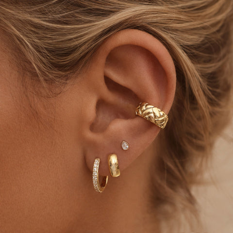 Thick gold ear cuff in a retro design. By Kurafuchi.