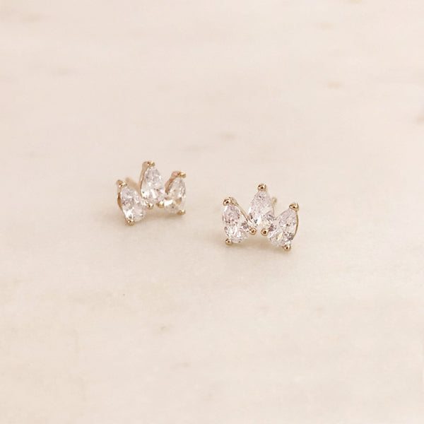 Sparkly gold stud earrings made of three teardrop-shaped zircon crystals.