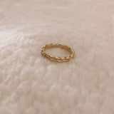 Simple gold band ring in a braided design.