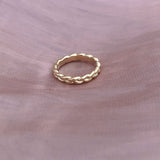 Simple gold band ring in a braided design.