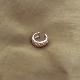 Thick gold ear cuff in a retro design. By Kurafuchi.