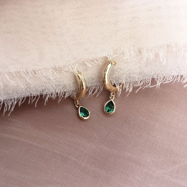 Lovely small gold hoops, each decorated with a teardrop-shaped green crystal zircon.