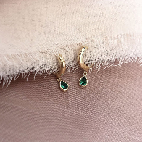 Lovely small gold hoops, each decorated with a teardrop-shaped green crystal zircon.