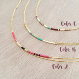 Elvira necklace made of double thin gold chain decorated with small beads in a multicolor pattern. Designed by Kurafuchi.