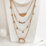 Layered necklaces in rose gold, featuring various chain styles and pendants, by Kurafuchi Jewelry.