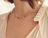 A female model wearing an Elvira minimalist rose gold dainty necklace by Kurafuchi Jewelry.