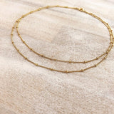 Double-strand necklace made with a delicate gold beaded chain. Designed by Kurafuchi.