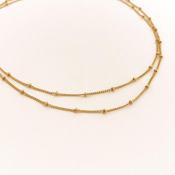 Double-strand necklace made with a delicate gold beaded chain. Designed by Kurafuchi.