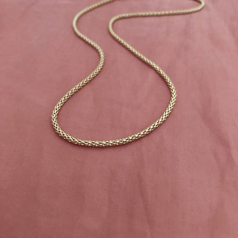 Elegant gold tube necklace by Kurafuchi.