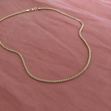 Elegant gold tube necklace by Kurafuchi.