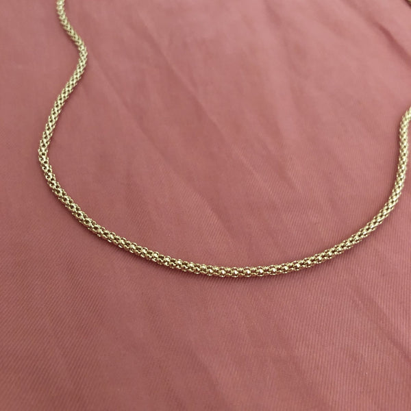 Elegant gold tube necklace by Kurafuchi.
