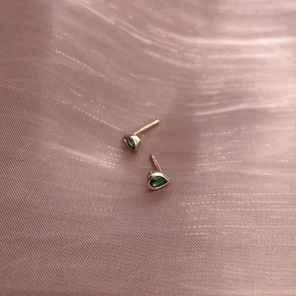Pretty teardrop-shaped stud earrings with green zircon crystals. By Kurafuchi.