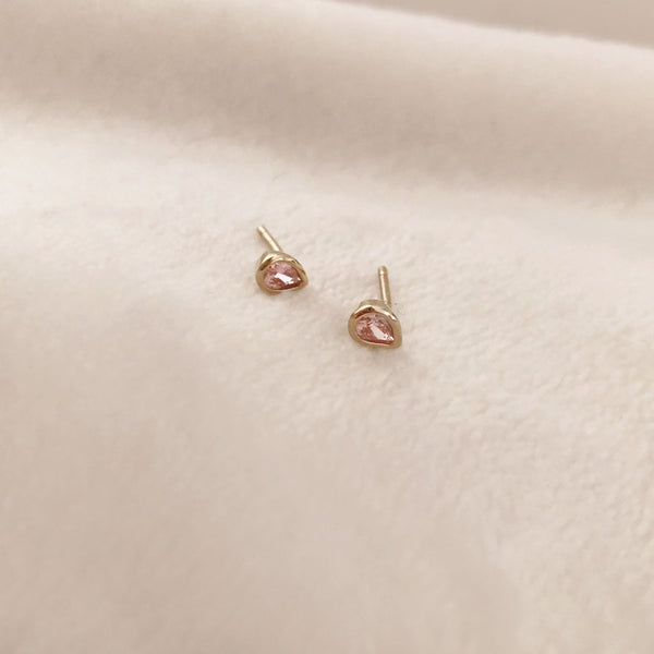 Pretty teardrop-shaped stud earrings with pink zircon crystals. By Kurafuchi.