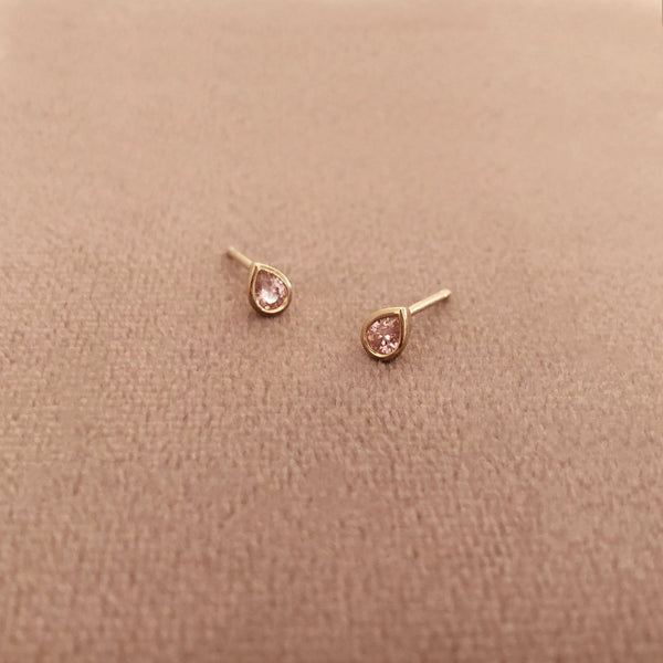 Pretty teardrop-shaped stud earrings with pink zircon crystals. By Kurafuchi.