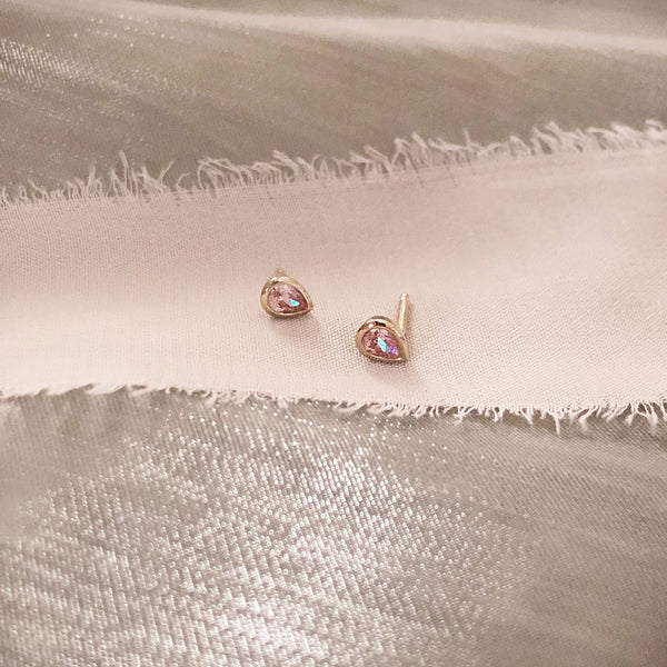 Pretty teardrop-shaped stud earrings with pink zircon crystals. By Kurafuchi.