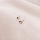 Pretty teardrop-shaped stud earrings with pink zircon crystals. By Kurafuchi.