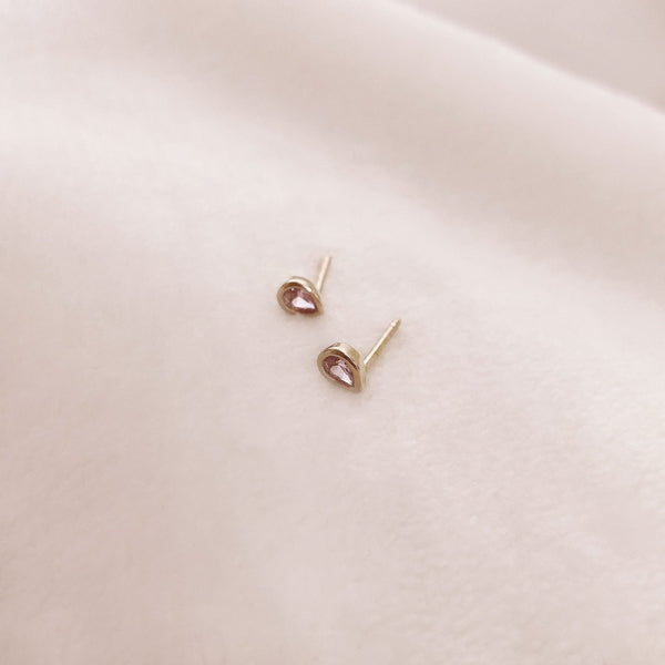 Pretty teardrop-shaped stud earrings with pink zircon crystals. By Kurafuchi.