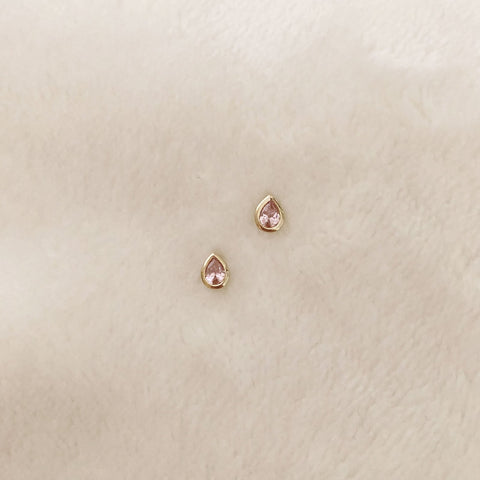Pretty teardrop-shaped stud earrings with pink zircon crystals. By Kurafuchi.