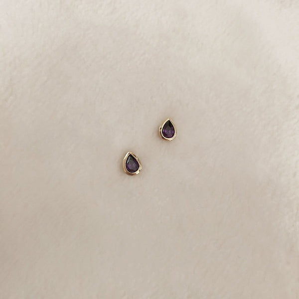 Pretty teardrop-shaped stud earrings with purple zircon crystals. By Kurafuchi.