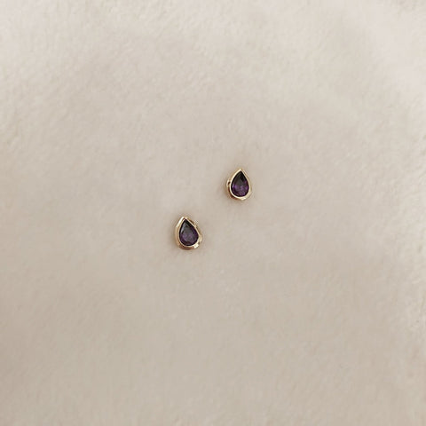 Pretty teardrop-shaped stud earrings with purple zircon crystals. By Kurafuchi.