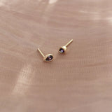 Pretty teardrop-shaped stud earrings with purple zircon crystals. By Kurafuchi.