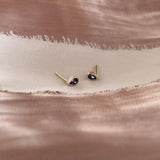 Pretty teardrop-shaped stud earrings with purple zircon crystals. By Kurafuchi.