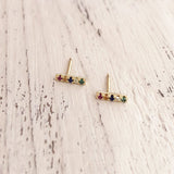 Multicolor stud earrings adorned with tiny zircons in red, blue, green and yellow and orange. By Kurafuchi.